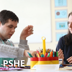 A student filling in a worksheet at his desk