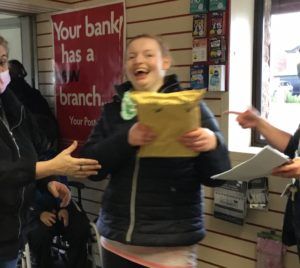 a student posting a parcel in the post office